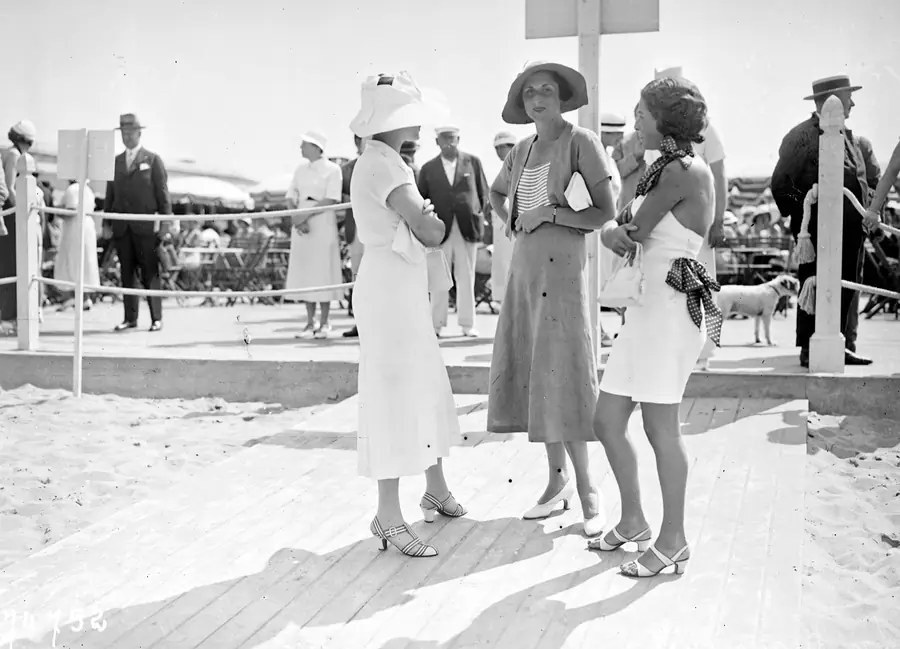 Elegant women in summer white on the beach at Deauville, 1933